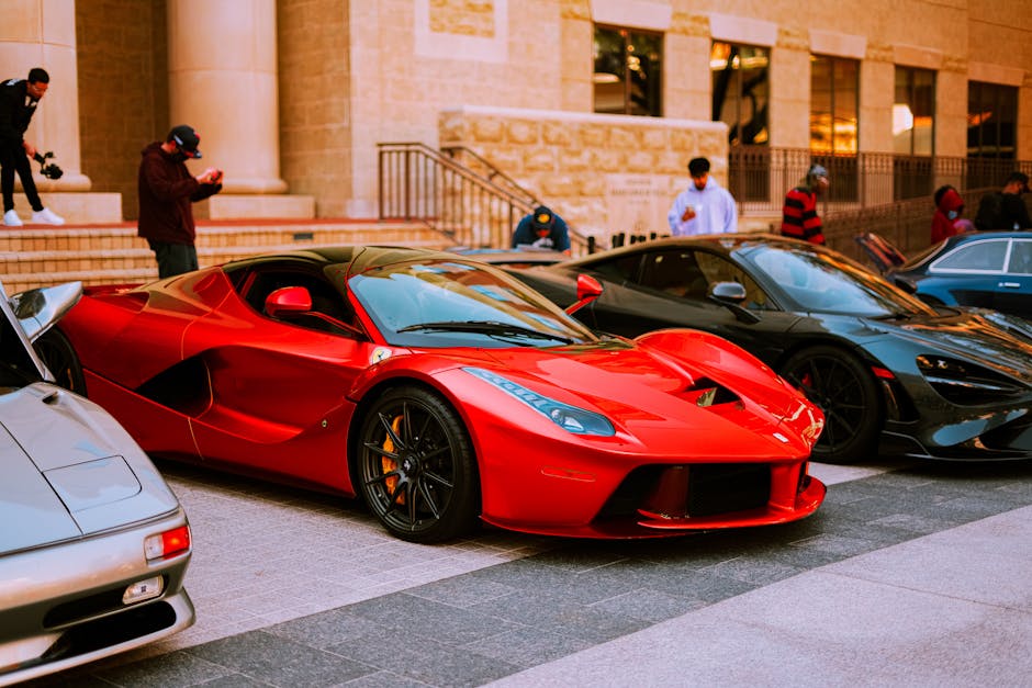 A lineup of luxury sports cars parked on an urban street during the day.