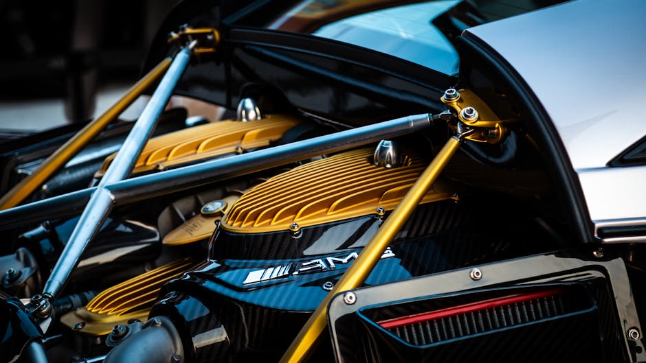 Detailed view of a luxury hypercar engine with gold and carbon fiber elements