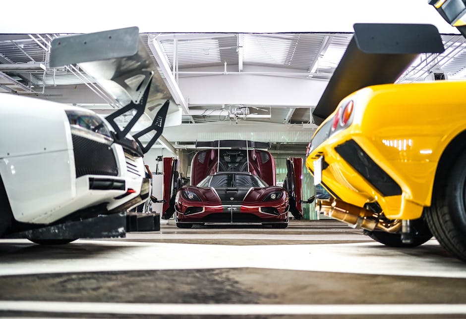 Vibrant supercars in a modern, well-lit garage showcasing sleek designs and engineering
